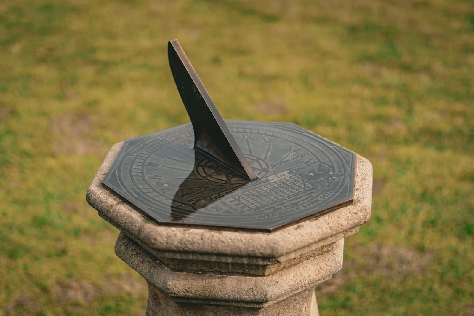 A classic stone sundial in a sunny Werribee South park setting.